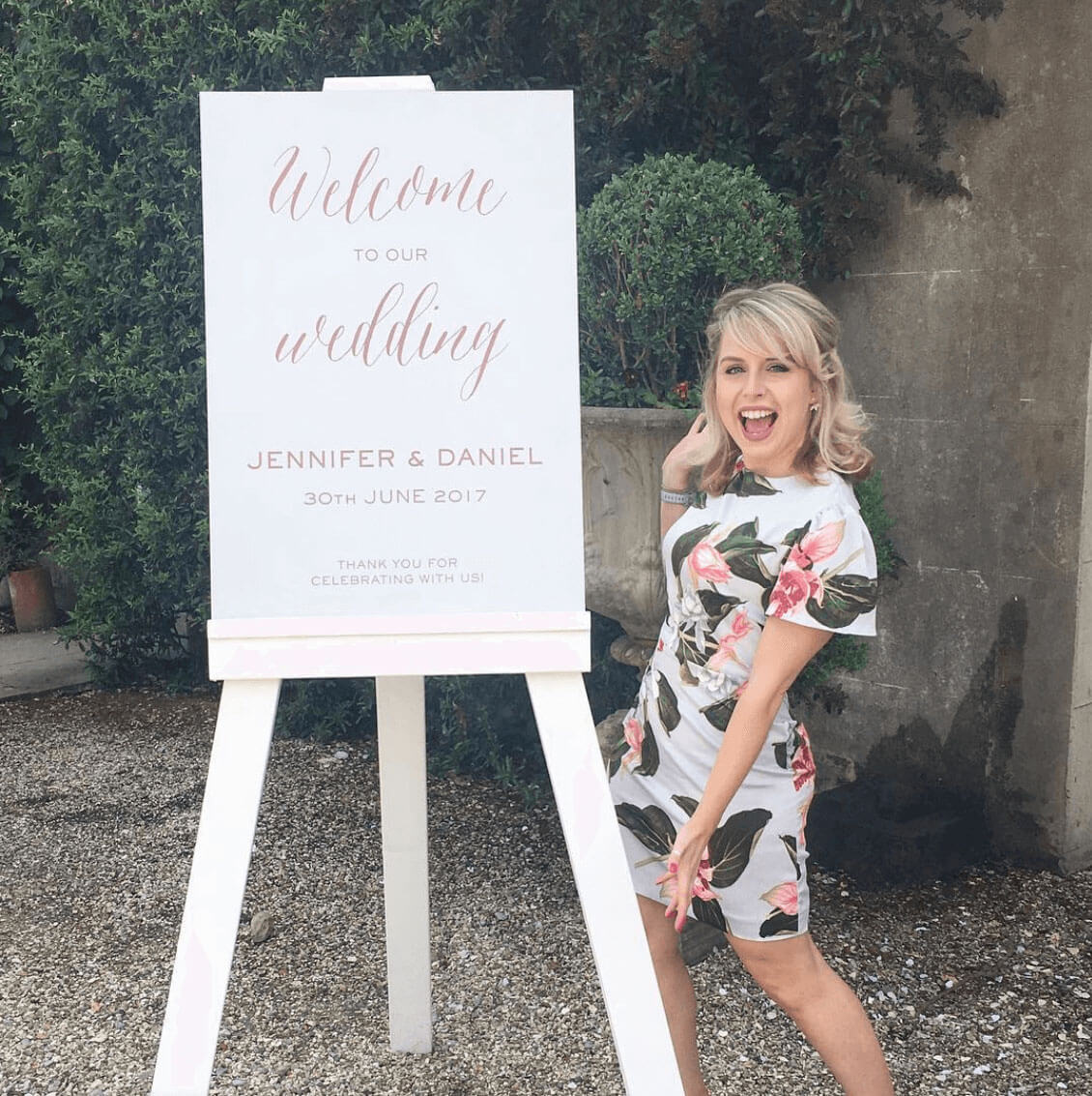 Laura with a wedding sign